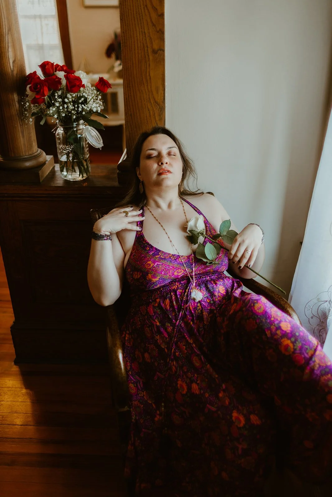 Safrianna relaxes as she holds a rose.