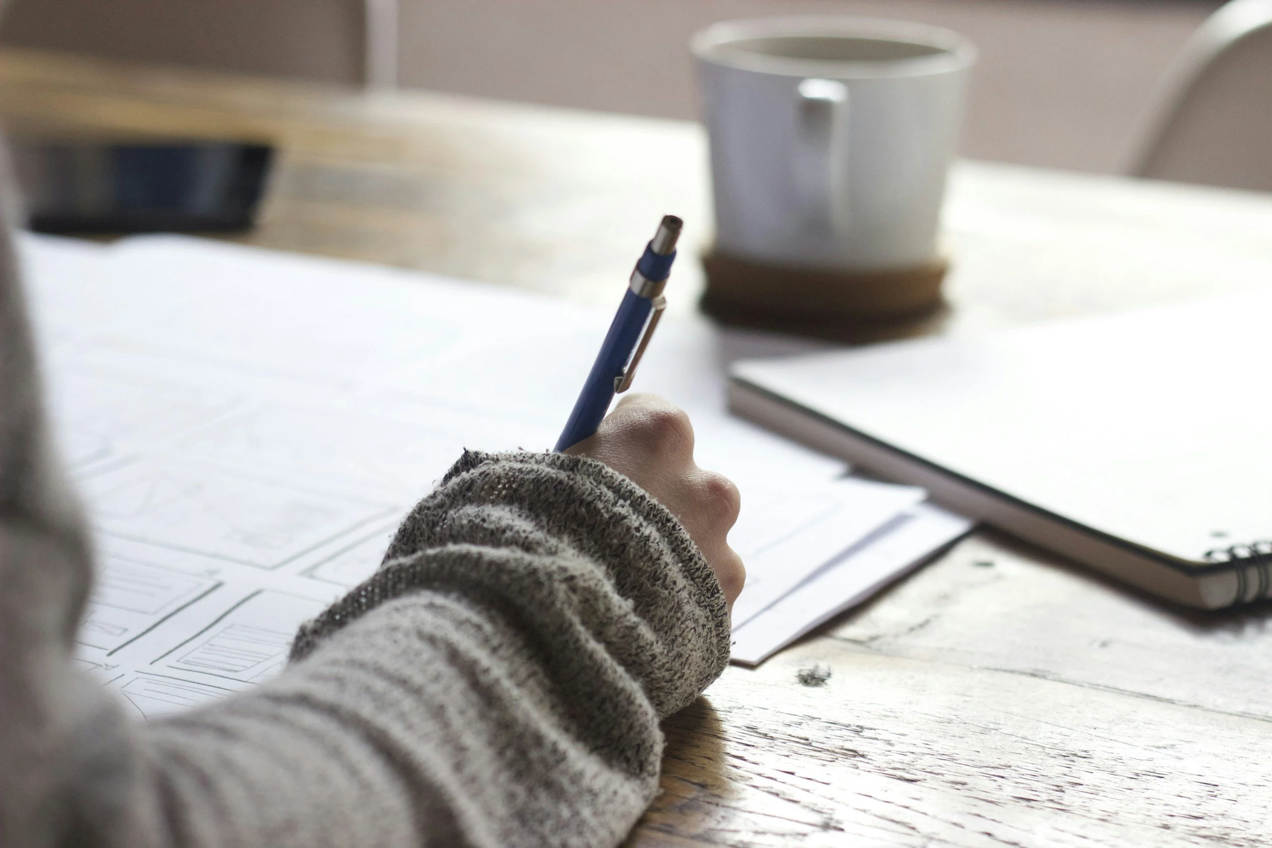 Person writing in a journal.